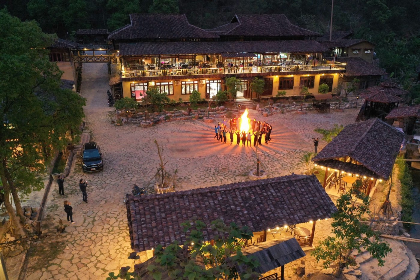 The night campfire in Mế’s courtyard, seen from above